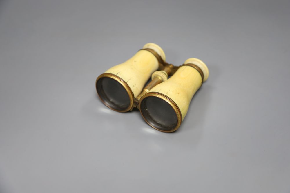 A cased pair of ivory mounted binoculars, leather cased